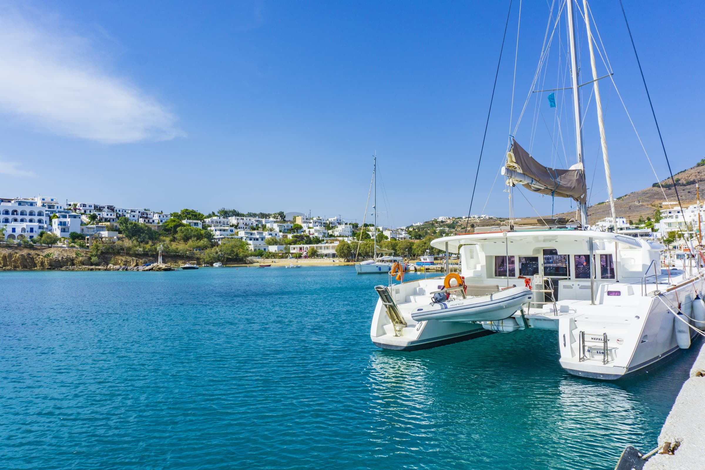 A luxury catamaran anchored in a turquoise Greek bay — Monobrow Private Catamaran Charters
